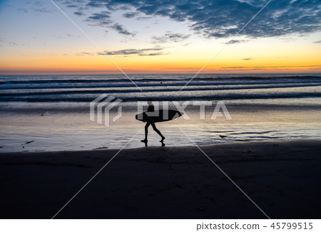 Silhouette of a surfer at sunset Silhouette of a surfer at sunset 45799515
