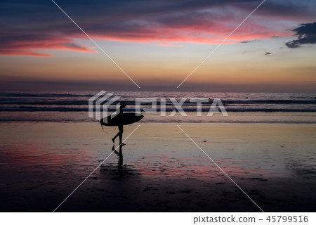 Silhouette of a surfer at sunset 45799516
