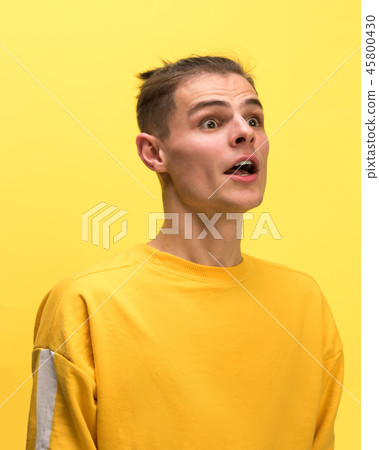 The man screaming with open mouth isolated on yellow background, concept face emotion 45800430
