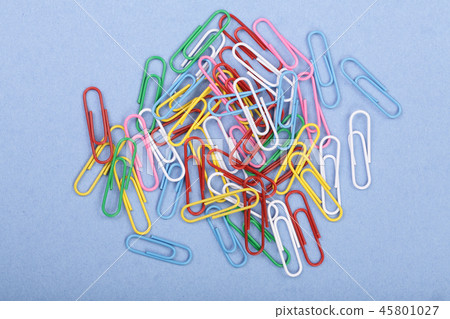 colorful paper clips on blue background. Top view colorful paper clips on blue background. Top view 45801027