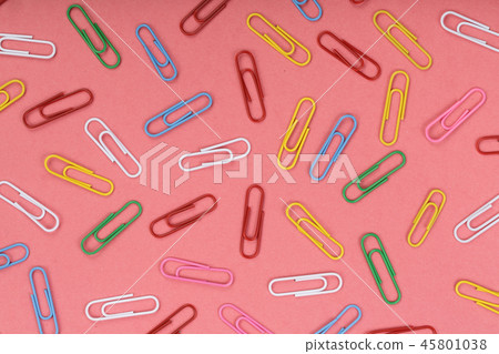 colorful paper clips on red background. Top view. Flat lay pattern 45801038