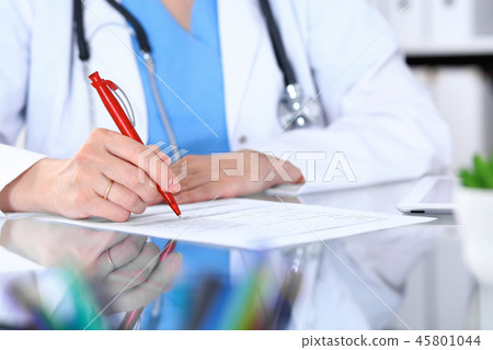 Woman doctor using tablet computer while sitting at the desk  in hospital office, closeup. Healthcar 45801044
