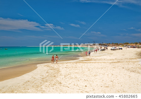 Vacationers strolling on the beautiful sandy beach 45802665