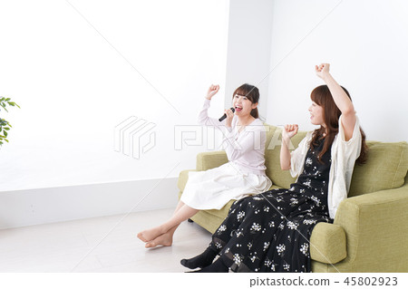A woman enjoying karaoke A woman enjoying karaoke 45802923