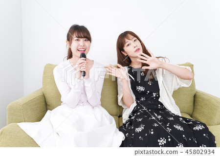 A woman enjoying karaoke 45802934