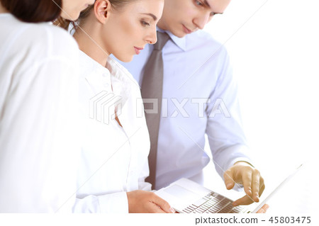 Group of business people using laptop computer while standing in office. Meeting and teamwork 45803475