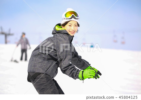A woman snowboarding 45804125