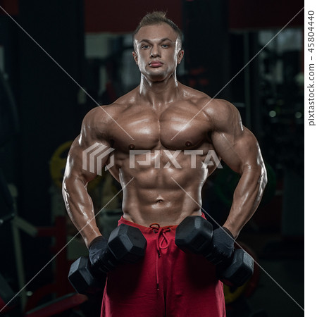 Muscular athletic bodybuilder fitness model posing 45804440