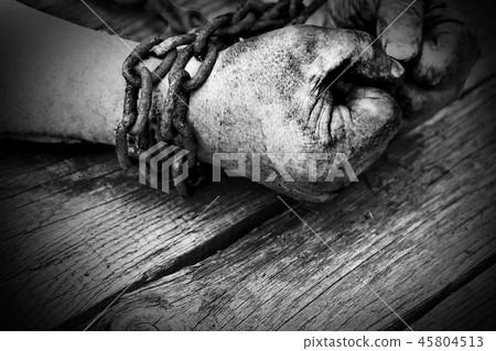 Powerful dirty male hands clenched into fists chained with rusty chain. Black and white photo. Powerful dirty male hands clenched into fists chained with rusty chain. Black and white photo. 45804513