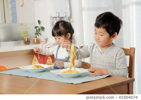 Brother eating pasta 45804674
