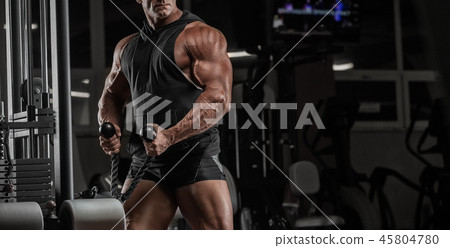 Handsome man with big muscles, posing at the camer Handsome man with big muscles, posing at the camer 45804780