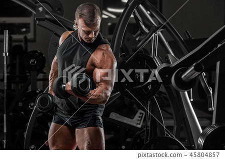 Handsome man with big muscles, posing at the camer Handsome man with big muscles, posing at the camer 45804857