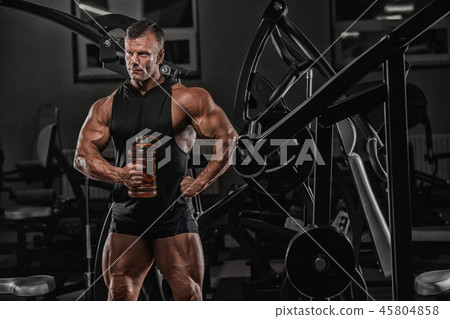 Handsome man with big muscles, posing at the camer Handsome man with big muscles, posing at the camer 45804858
