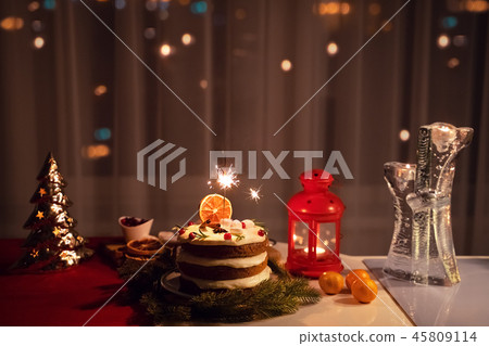A Sparkler in the cake at night at Christmas time A Sparkler in the cake at night at Christmas time 45809114