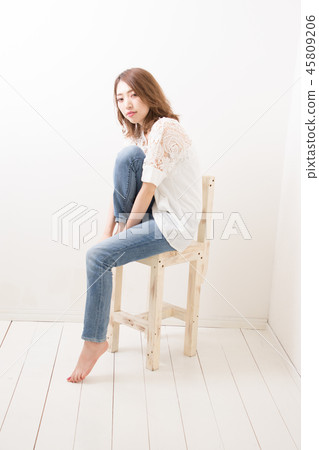 Woman sitting on chair 45809206