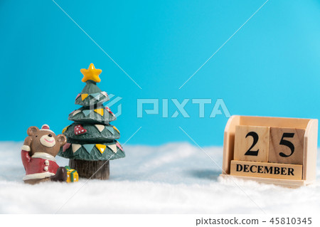 Brown bear wearing a Christmas hat sitting Beside 45810345