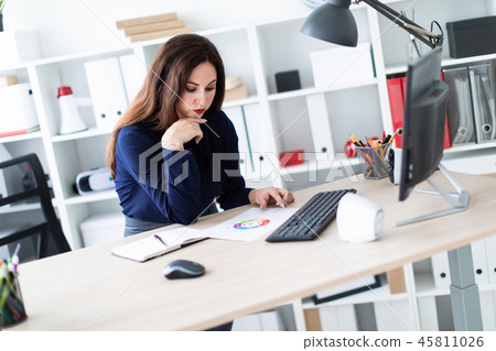 A young girl working with documents on the computer. 45811026