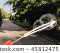 Double soap bubble on the background of city park. 45812475