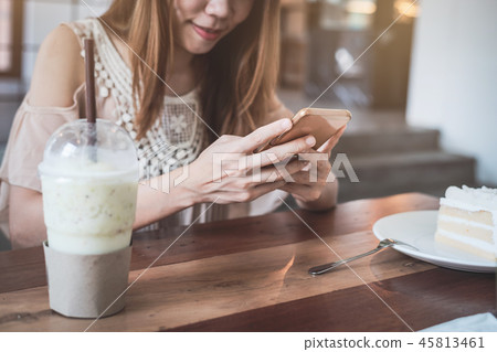 Young woman using smart phone in cafe 45813461