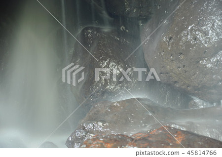 waterfall in cave behind rock in forest waterfall in cave behind rock in forest 45814766