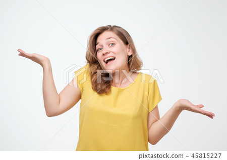 Young happy student shrugging in doubt. Is in not my business 45815227