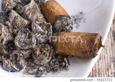 Ash cigars in the ashtray 45815711