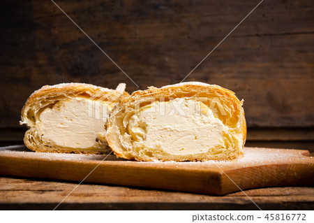Vanilla cream roll pastry on a board 45816772