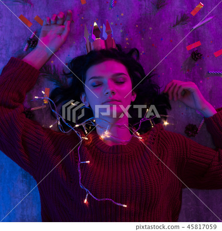 Young woman lying with xmas glowing lights Celebration, Christmas, New Year. Young woman lying with xmas glowing lights Celebration, Christmas, New Year. 45817059