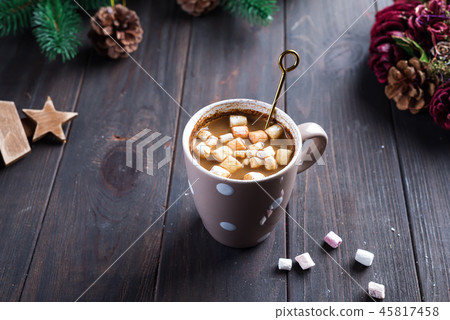 Hot cappuccino with marshmallows in a ceramic cup with honey and metal honey stick on a wooden dark Hot cappuccino with marshmallows in a ceramic cup with honey and metal honey stick on a wooden dark 45817458