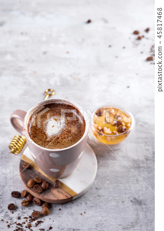 Coffee cup with chocolate cookies on stone background with honey and metal honey stick with copy Coffee cup with chocolate cookies on stone background with honey and metal honey stick with copy 45817468