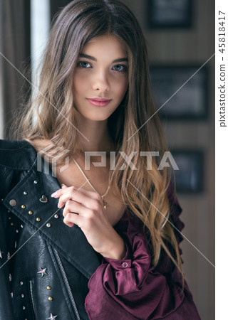 Young beautiful girl in a leather jacket Young beautiful girl in a leather jacket 45818417