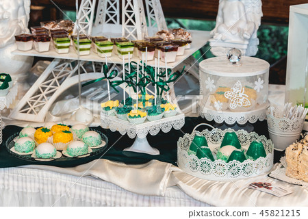 green style wedding candy bar on a white table. cupcakes decorated with a green ribbon bow green style wedding candy bar on a white table. cupcakes decorated with a green ribbon bow 45821215