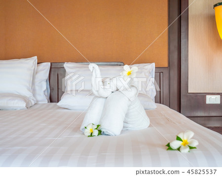 White elephant towel and comfortable pillow on bed White elephant towel and comfortable pillow on bed 45825537