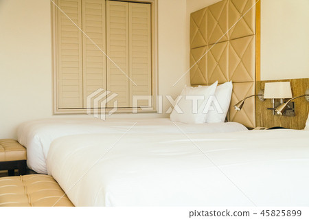 White comfortable pillow on bed decoration in hotel bedroom White comfortable pillow on bed decoration in hotel bedroom 45825899
