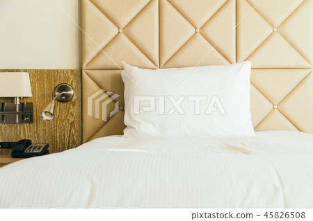 White comfortable pillow on bed decoration in hotel bedroom White comfortable pillow on bed decoration in hotel bedroom 45826508