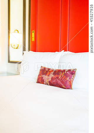 Comfotable pillow on bed with light lamp decoration Comfotable pillow on bed with light lamp decoration 45827916