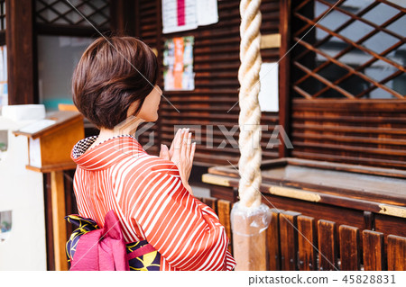 A woman visiting a shrine A woman visiting a shrine 45828831