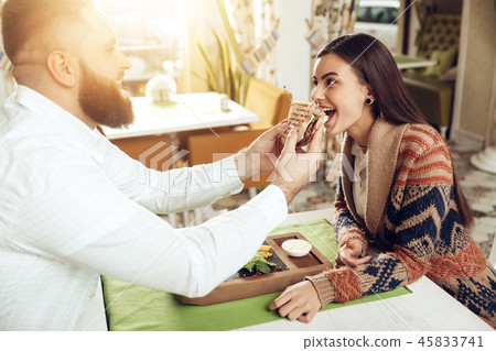 Happy man and woman having lunch in a restaurant 45833741