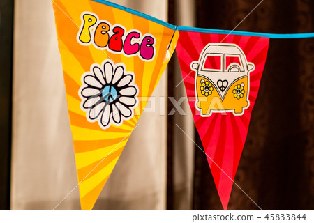 hippie peace text and love flower power van on a hanging party sign over a blurred background 45833844