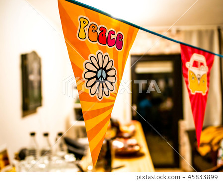 hippie peace text and love flower power van on a hanging party sign over a blurred background 45833899