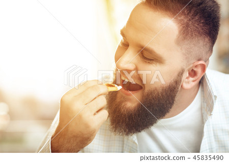 Portrait of man eating in cafe and enjoying food 45835490