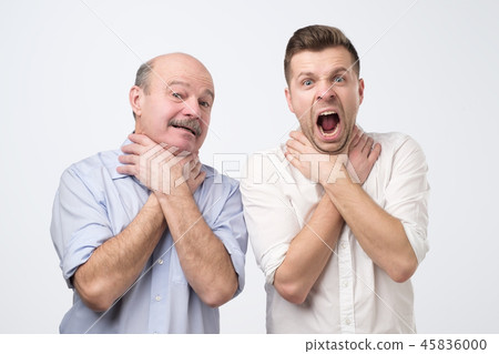 Two men showing choking gesture like they have problems with breathing. 45836000