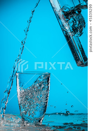 Man pours water from glass 45839299