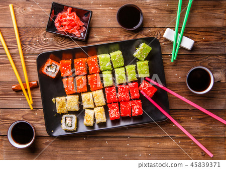 Sushi Set rolls with soy sauce served on black plate Sushi Set rolls with soy sauce served on black plate 45839371
