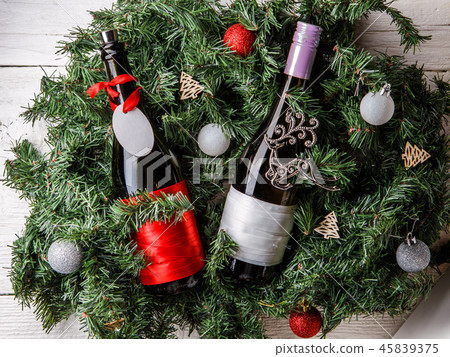Photo of spruce branches with two bottles of wine, blank greeting card 45839375