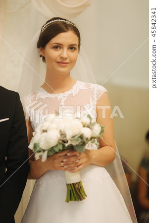 Bride with bouquet of flowers in the church 45842341