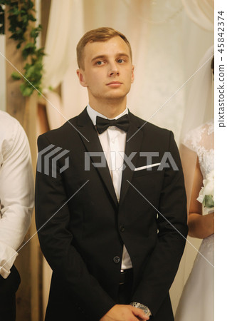 Groom stand in the church. Wedding ceremony Groom stand in the church. Wedding ceremony 45842374