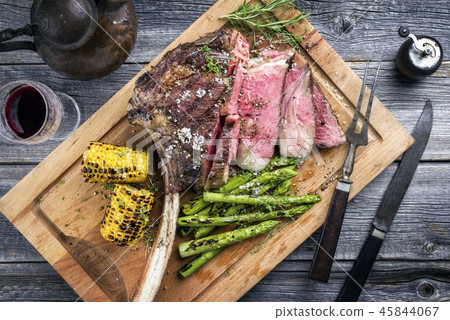 Barbecue Wagyu Tomahawk Steak as top view on burnt 45844067