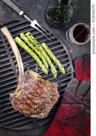 Barbecue Wagyu Tomahawk Steak as top view on burnt Barbecue Wagyu Tomahawk Steak as top view on burnt 45844070