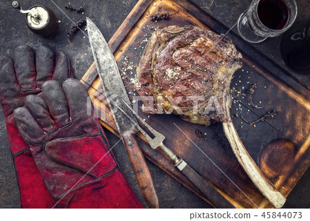 Barbecue Wagyu Tomahawk Steak as top view on burnt 45844073